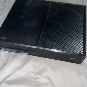 An Xbox One with one controller and a charging kit